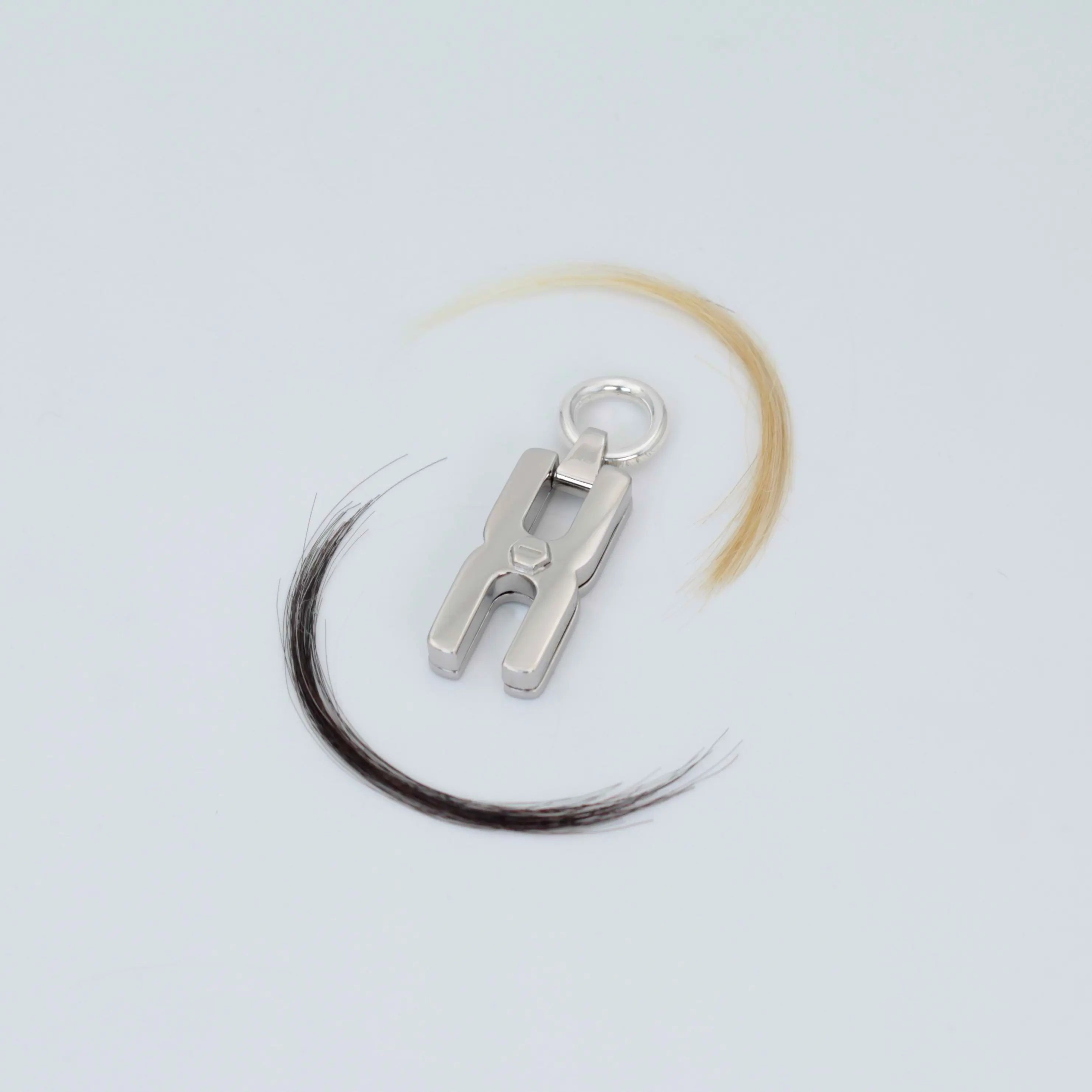 Gros plan du fermoir et de la chaîne maille forçat du pendentif Hera R en argent rhodié, finition artisanale française Alhiage